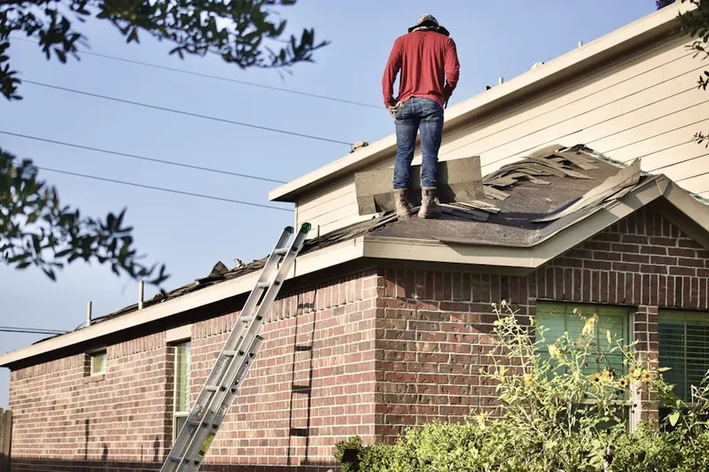 Professional roofer working on a residential roof in Woodfield